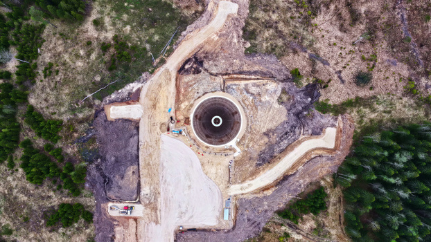 Aerial view of a wind turbine foundation under construction in a forest clearing in Latvija. Aerial view of a wind turbine foundation under construction in a forest clearing in Latvija.