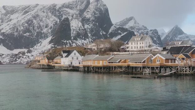 View of Hamn&oslash;y village with snow capped mountains Norway.
