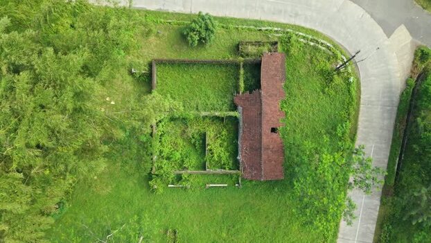 Aerial view of ruined house overgrown with vegetation Indonesia. Aerial view of ruined house overgrown with vegetation Indonesia.