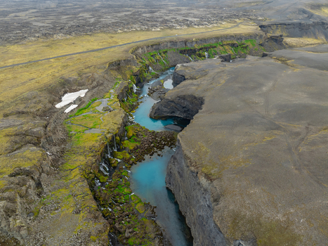 Aerial view of Sigoldugljufur canyon featuring a vibrant turquoise river flowing through moss covered volcanic cliffs in Rangarthing ytra Iceland. Aerial view of Sigoldugljufur canyon featuring a vibrant turquoise river flowing through moss covered volcanic cliffs in Rangarthing ytra Iceland.