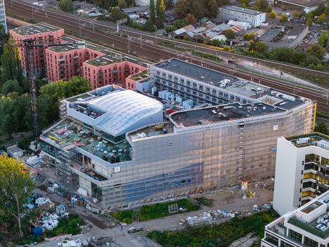 Aerial view of the Ocean Berlin Hotel and Aquarium under construction featuring scaffolding a curved glass roof and surrounding urban infrastructure in Berlin Berlin Germany. Aerial view of the Ocean Berlin Hotel and Aquarium under construction featuring scaffolding a curved glass roof and surrounding urban infrastructure in Berlin Berlin Germany.
