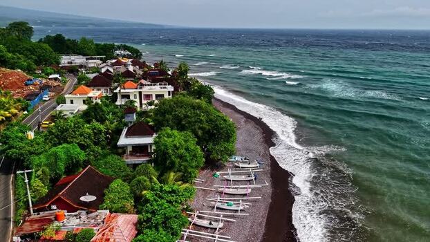 Aerial view of coastal village and traditional boats Indonesia.