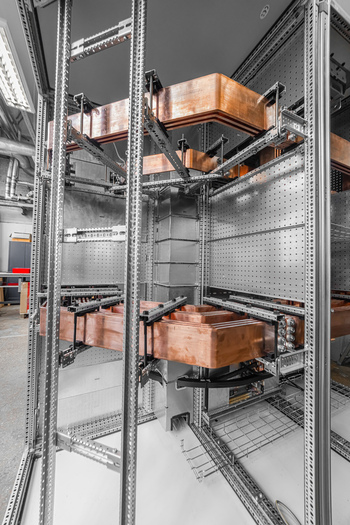 View of copper busbars installed inside an industrial electrical cabinet with metal framing and technical components in Latvia. View of copper busbars installed inside an industrial electrical cabinet with metal framing and technical components in Latvia.