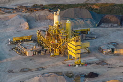 Aerial view of a sand and gravel mine featuring industrial machinery conveyor belts and piles of processed aggregate in Sobolewo Podlaskie Voivodeship Poland. Aerial view of a sand and gravel mine featuring industrial machinery conveyor belts and piles of processed aggregate in Sobolewo Podlaskie Voivodeship Poland.