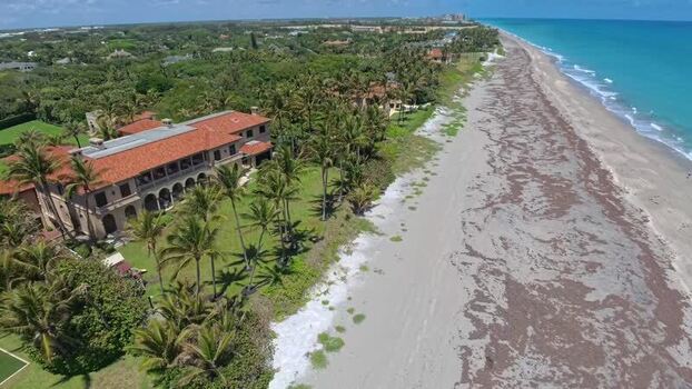 Aerial view of a beachfront estate in North Palm Beach United States. Aerial view of a beachfront estate in North Palm Beach United States.