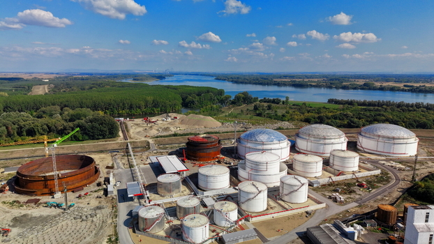 Aerial view of fuel tanks at a storage facility near the Danube river with construction equipment and industrial infrastructure in Kovin Vojvodina Serbia. Aerial view of fuel tanks at a storage facility near the Danube river with construction equipment and industrial infrastructure in Kovin Vojvodina Serbia.