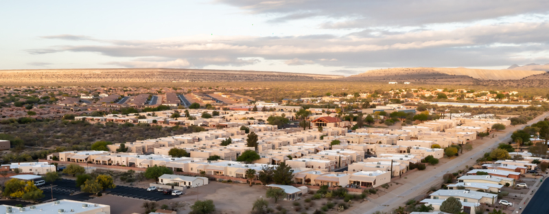 Aerial view of a planned residential community in Green Valley Arizona with organized streets low rise homes desert landscaping and surrounding hills. Aerial view of a planned residential community in Green Valley Arizona with organized streets low rise homes desert landscaping and surrounding hills.