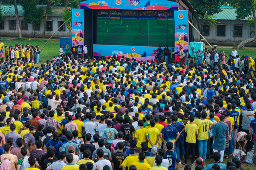 Dhaka Bangladesh 20 June 2026 Aerial view of Dhaka University Campus with a large crowd of football fans watching a match on a giant screen in an outdoor fan zone. Dhaka Bangladesh 20 June 2026 Aerial view of Dhaka University Campus with a large crowd of football fans watching a match on a giant screen in an outdoor fan zone.