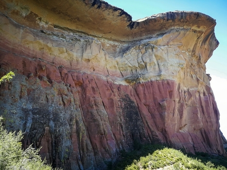 View of the dramatic layered sandstone cliffs of Golden Gate Highlands National Park with rugged rock formations and sparse vegetation in Clarens Free State South Africa. View of the dramatic layered sandstone cliffs of Golden Gate Highlands National Park with rugged rock formations and sparse vegetation in Clarens Free State South Africa.