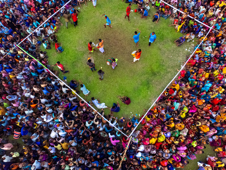 Nilphamari Bangladesh 01 May 2026 Aerial view of a large crowd gathered around a square green field during a traditional festival with drummers performing in the center. Nilphamari Bangladesh 01 May 2026 Aerial view of a large crowd gathered around a square green field during a traditional festival with drummers performing in the center.