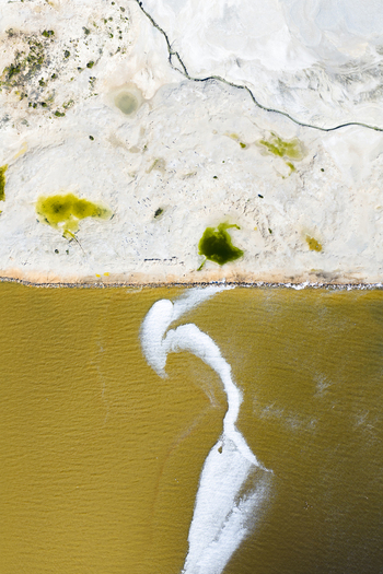 Aerial view of stark white sands meeting the golden waters divided by a serene shoreline San Pedro del Pinatar Region of Murcia Spain. Aerial view of stark white sands meeting the golden waters divided by a serene shoreline San Pedro del Pinatar Region of Murcia Spain.