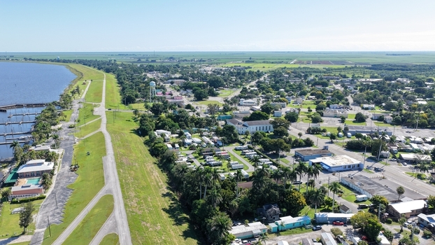 Aerial view of the town of Pahokee situated along the shores of Lake Okeechobee with a marina residential areas and lush greenery in Pahokee Florida United States.