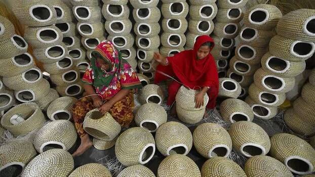 View of women weaving traditional baskets in Bogura Bangladesh. View of women weaving traditional baskets in Bogura Bangladesh.
