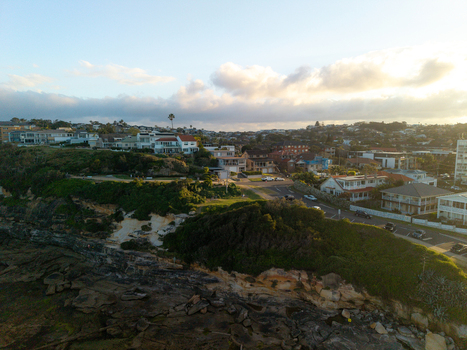 Aerial view of Dee Why coastline featuring residential houses on the cliffside rocky shore and coastal roads in Dee Why New South Wales Australia. Aerial view of Dee Why coastline featuring residential houses on the cliffside rocky shore and coastal roads in Dee Why New South Wales Australia.
