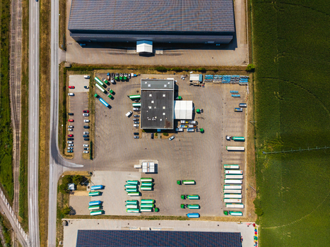 Aerial view of Hombourg Logistic park featuring large warehouse buildings rows of parked trucks and trailers and surrounding agricultural fields in Hombourg Grand Est France.