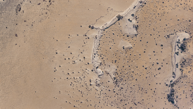 Aerial view of intricate sand patterns and sparse desert vegetation across the arid landscape in Denham Western Australia Australia. Aerial view of intricate sand patterns and sparse desert vegetation across the arid landscape in Denham Western Australia Australia.