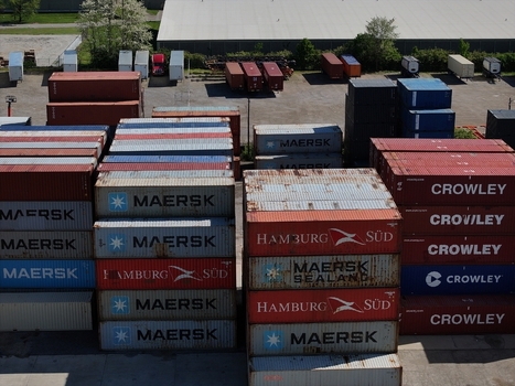 Cincinnati United States 19 April 2026 Aerial view of stacks of colorful shipping containers from Maersk Hamburg Sud and Crowley in a logistics yard under bright daylight.