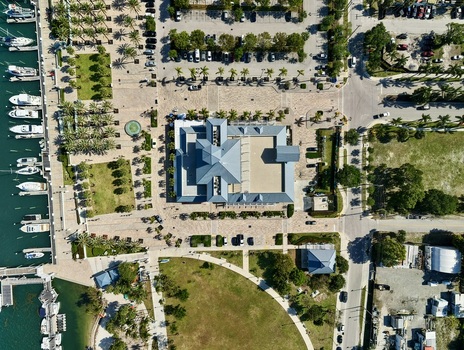 Aerial view of Riviera Beach Marina Village featuring the modern building complex docked boats in the marina and palm lined walkways in Riviera Beach Florida United States. Aerial view of Riviera Beach Marina Village featuring the modern building complex docked boats in the marina and palm lined walkways in Riviera Beach Florida United States.