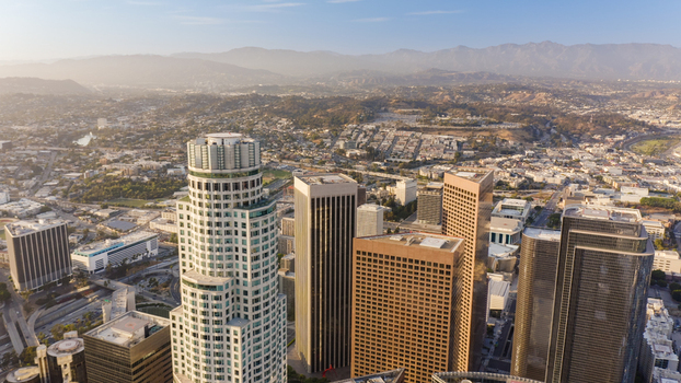 Aerial view of modern skyscrapers and glass office buildings rising above the urban landscape of Los Angeles California United States.