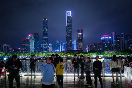 Guangzhou Guangdong Province China 22 February 2024 View of the illuminated Guangzhou skyline at night with people standing on the waterfront promenade. Guangzhou Guangdong Province China 22 February 2024 View of the illuminated Guangzhou skyline at night with people standing on the waterfront promenade.