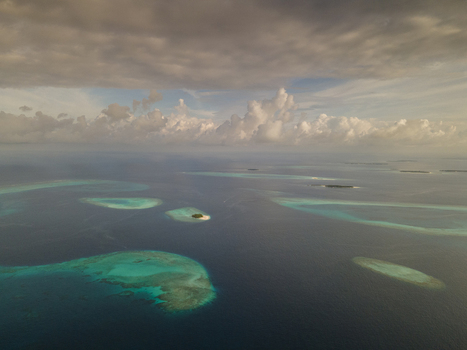 Aerial view of islands with white beach and blue ocean Baa Atoll Maldives.