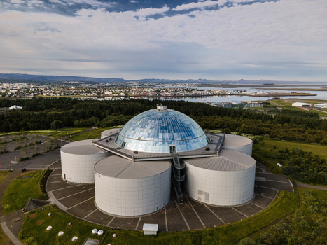 Aerial view of Perlan museum with its iconic glass dome surrounded by lush greenery with the bay in the background Reykjavik Reykjavikurborg Iceland. Aerial view of Perlan museum with its iconic glass dome surrounded by lush greenery with the bay in the background Reykjavik Reykjavikurborg Iceland.