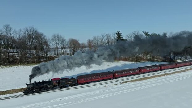 Aerial view of a steam train in a snowy landscape United States. Aerial view of a steam train in a snowy landscape United States.
