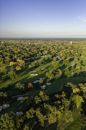 Aerial view of a golf course in autumn with vibrant fall foliage sand bunkers and lush green fairways in Glenview Illinois United States. Aerial view of a golf course in autumn with vibrant fall foliage sand bunkers and lush green fairways in Glenview Illinois United States.