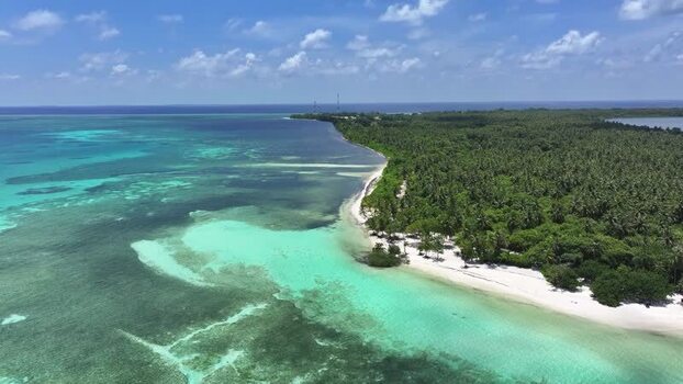 Aerial view of tropical island coastline and coral reefs Maldives. Aerial view of tropical island coastline and coral reefs Maldives.