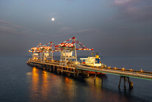 Aerial view of Orot Rabin Power Plant with large cranes and a cargo ship docked at the pier during twilight in Hadera Haifa District Israel. Aerial view of Orot Rabin Power Plant with large cranes and a cargo ship docked at the pier during twilight in Hadera Haifa District Israel.