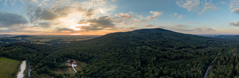 Aerial view of Sleza Mountain at sunset from Przelecz Tapadla in summer surrounded by dense forests and rolling hills in Sleza Landscape Park Lower Silesia Poland. Aerial view of Sleza Mountain at sunset from Przelecz Tapadla in summer surrounded by dense forests and rolling hills in Sleza Landscape Park Lower Silesia Poland.