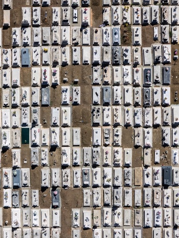 Aerial view of the cemetery with rows of white stone tombs and floral tributes in Evora Evora District Portugal. Aerial view of the cemetery with rows of white stone tombs and floral tributes in Evora Evora District Portugal.
