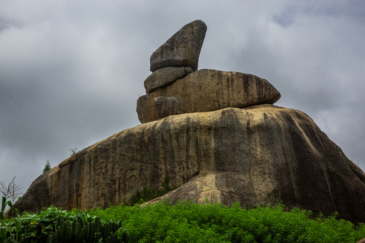 View of the stacked rock formation in the landscape with green vegetation under a cloudy sky in Jos Plateau Nigeria. View of the stacked rock formation in the landscape with green vegetation under a cloudy sky in Jos Plateau Nigeria.