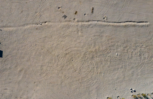 Aerial view of Sarfaranga Cold Desert Shigar with intricate tire tracks across the sandy terrain in Skardu Gilgit Pakistan. Aerial view of Sarfaranga Cold Desert Shigar with intricate tire tracks across the sandy terrain in Skardu Gilgit Pakistan.