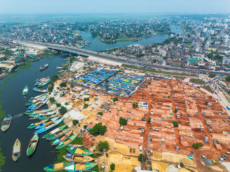Aerial view of the contrasting textures of boats on the Buriganga River meeting the bustling markets and brickyards Dhaka Dhaka Division Bangladesh. Aerial view of the contrasting textures of boats on the Buriganga River meeting the bustling markets and brickyards Dhaka Dhaka Division Bangladesh.