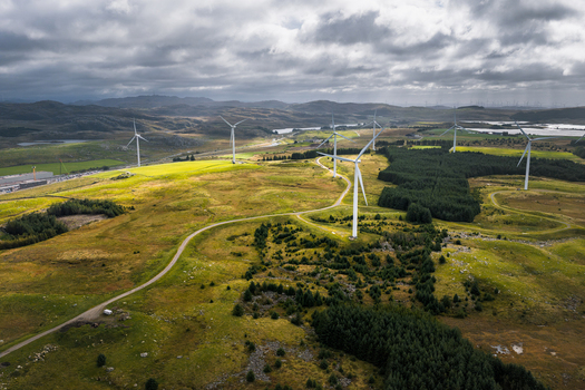 Aerial view of Hog Jaeren vindkraftverk wind farm with large turbines set in a rolling green landscape under a cloudy sky in Ha Municipality Rogaland Norway. Aerial view of Hog Jaeren vindkraftverk wind farm with large turbines set in a rolling green landscape under a cloudy sky in Ha Municipality Rogaland Norway.