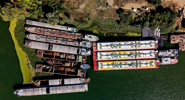Aerial view of cargo barges and tankers docked at the shipyard along the Danube river in Smederevo Podunavlje District Serbia.