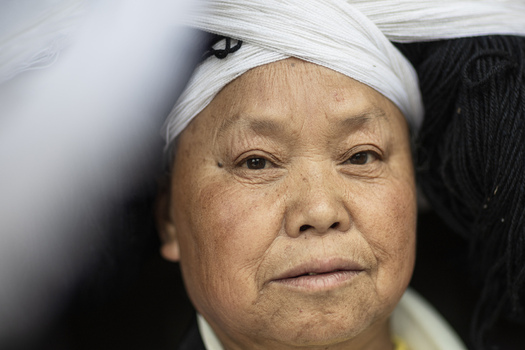 Gaoxing China 29 April 2026 View of an elderly Long Horn Miao woman wearing a traditional large headpiece made of white and black yarn. Gaoxing China 29 April 2026 View of an elderly Long Horn Miao woman wearing a traditional large headpiece made of white and black yarn.