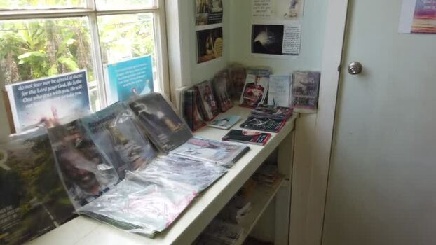 View of a door with a sign and a bookshelf with books Pitcairn Islands.