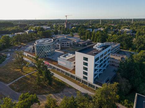 Diepenbeek Vlaanderen Belgium 01 July 2026 Aerial view of the University College Leuven Limburg Campus Diepenbeek with its modern cylindrical building green roofs and surrounding trees. Diepenbeek Vlaanderen Belgium 01 July 2026 Aerial view of the University College Leuven Limburg Campus Diepenbeek with its modern cylindrical building green roofs and surrounding trees.