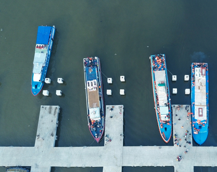 Aerial view of Port of Kali Adem with numerous boats docked at the pier and calm coastal waters in Kecamatan Penjaringan Daerah Khusus Ibukota Indonesia. Aerial view of Port of Kali Adem with numerous boats docked at the pier and calm coastal waters in Kecamatan Penjaringan Daerah Khusus Ibukota Indonesia.