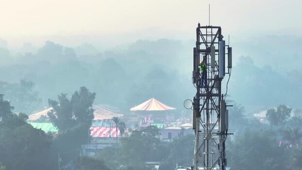 Aerial view of a technician working on a cell tower Bangladesh.