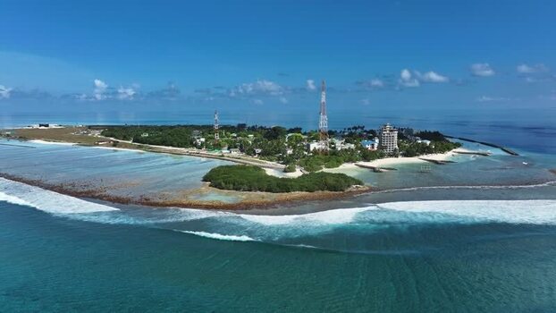 Aerial view of Thulusdhoo island with turquoise water and waves Maldives. Aerial view of Thulusdhoo island with turquoise water and waves Maldives.