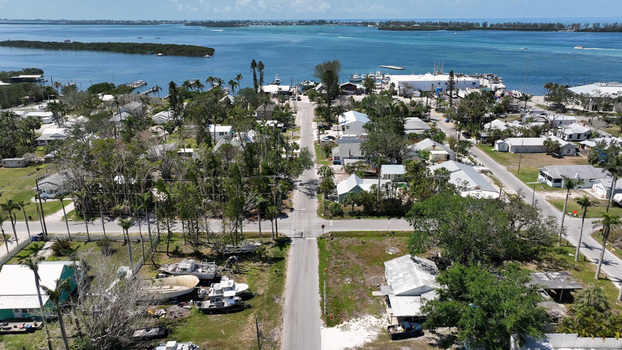 Aerial view of the historic fishing village of Cortez featuring residential houses lush trees and boats docked along the waterfront in Cortez Florida United States. Aerial view of the historic fishing village of Cortez featuring residential houses lush trees and boats docked along the waterfront in Cortez Florida United States.