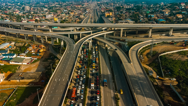 Aerial view of the multi level Pokuase Interchange with heavy traffic flowing on concrete overpasses surrounded by urban development in Ga North Municipal Greater Accra Region Ghana. Aerial view of the multi level Pokuase Interchange with heavy traffic flowing on concrete overpasses surrounded by urban development in Ga North Municipal Greater Accra Region Ghana.