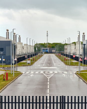 Middenmeer Netherlands 17 May 2026 View of Microsoft datacenters on Agriport with modern industrial buildings asphalt roads and streetlights under an overcast sky.