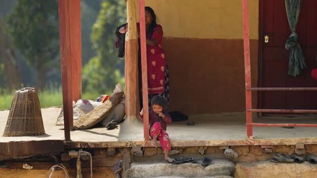 View of a woman and child at a traditional house Nepal. View of a woman and child at a traditional house Nepal.