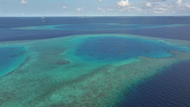 Aerial view of turquoise coral reefs in the Indian Ocean Maldives. Aerial view of turquoise coral reefs in the Indian Ocean Maldives.