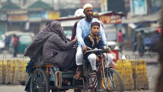 View of a family riding a rickshaw in Bogura Bangladesh. View of a family riding a rickshaw in Bogura Bangladesh.