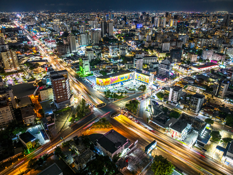 Aerial view of the intersection of Avenida Tiradentes and Avenida 27 de Febrero at night with light trails buildings and Santo Domingo Distrito Nacional Dominican Republic. Aerial view of the intersection of Avenida Tiradentes and Avenida 27 de Febrero at night with light trails buildings and Santo Domingo Distrito Nacional Dominican Republic.